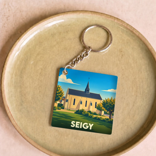 Porte-clés souvenir de la ville de Seigy avec une illustration stylisée de son église.