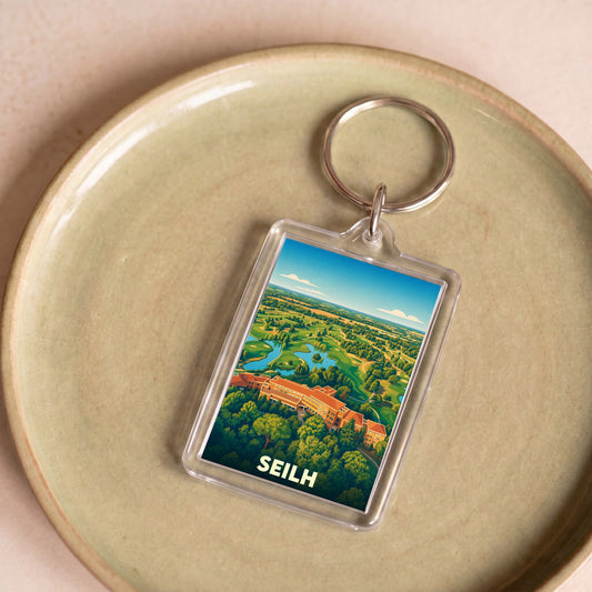 Porte-clés souvenir de la ville de Seilh avec une illustration stylisée de son golf.
