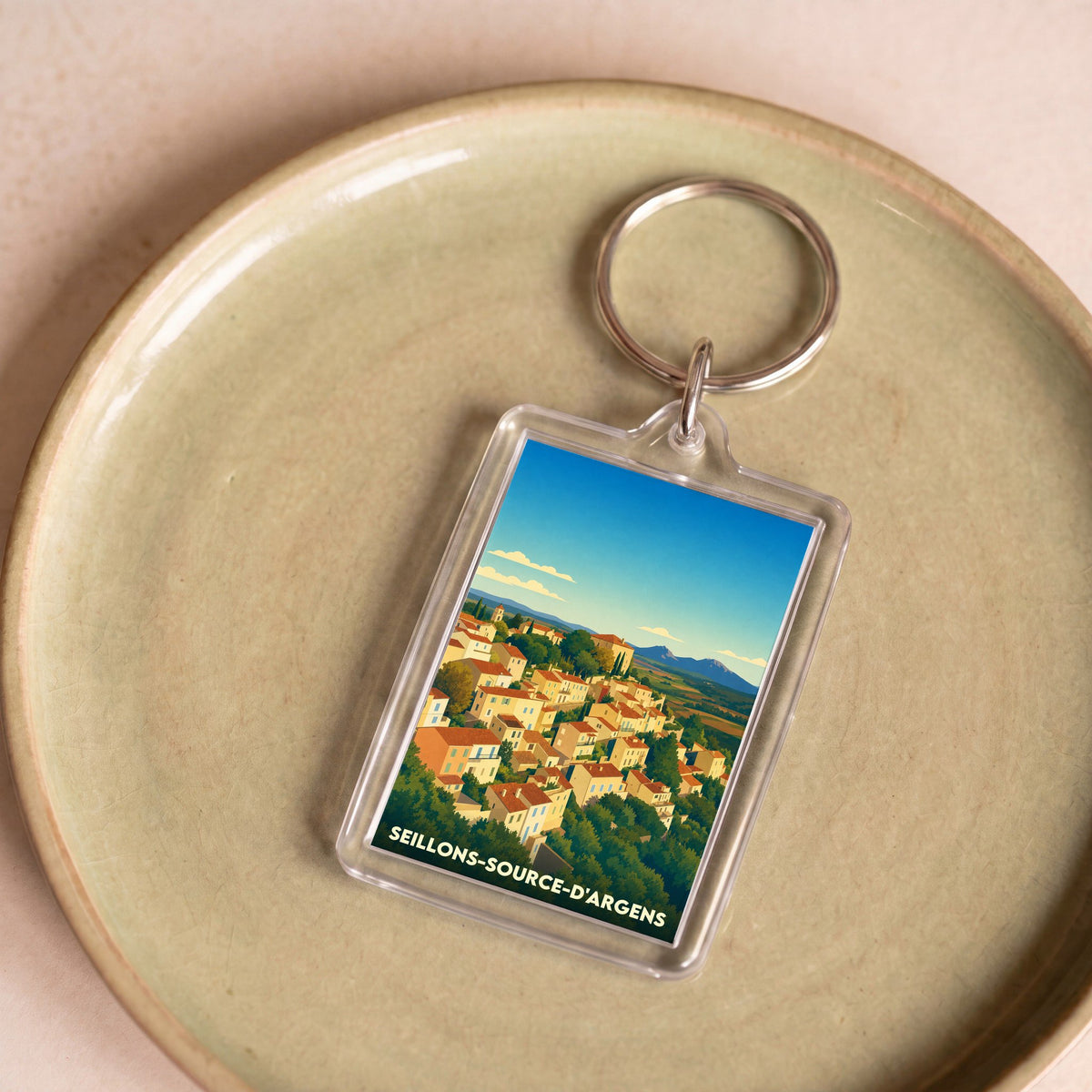 Porte-clés souvenir de la ville de Seillons-Source-d'Argens avec une illustration stylisée.