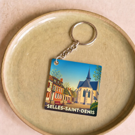 Porte-clés souvenir de la ville de Selles-Saint-Denis avec une illustration stylisée.