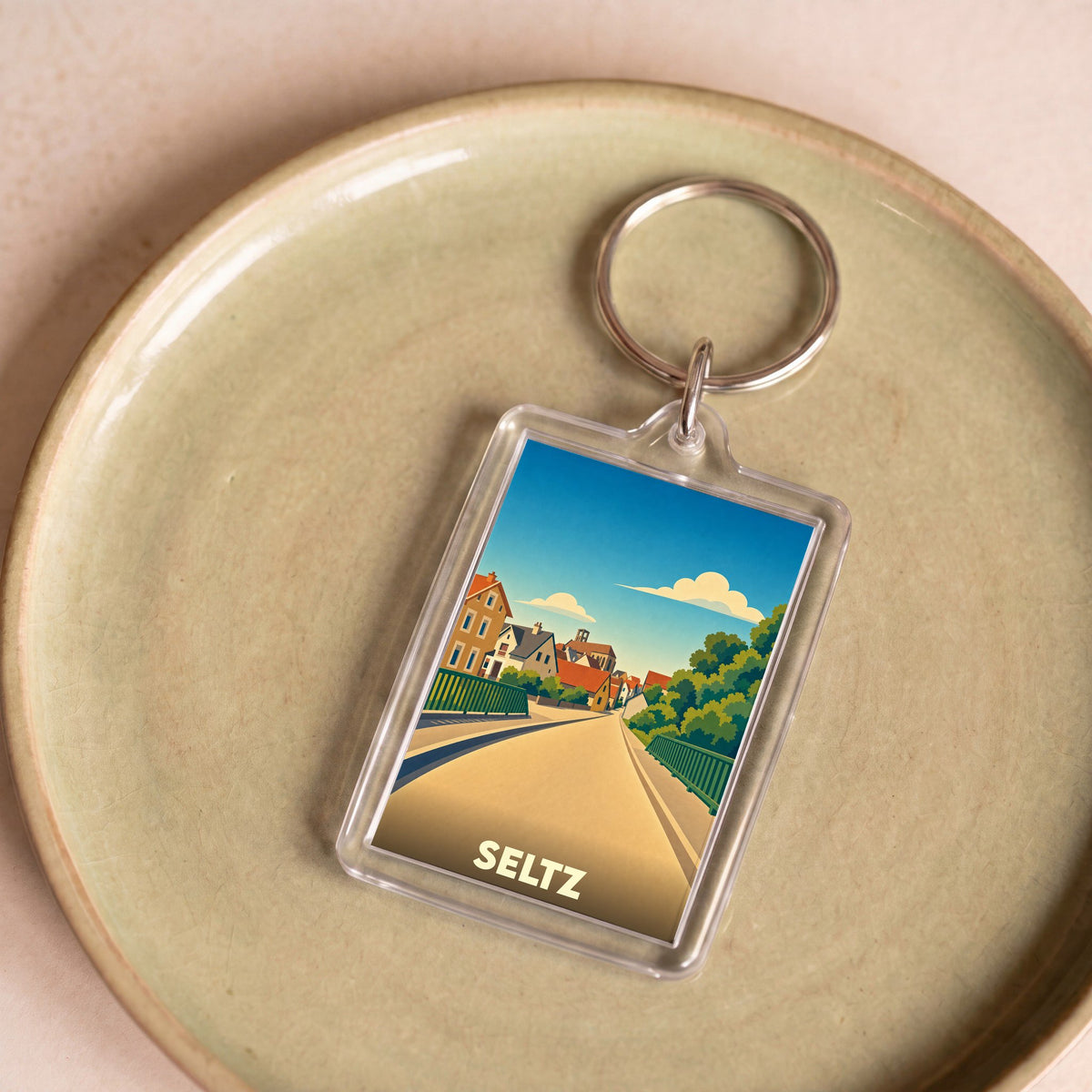 Porte-clés souvenir de la ville de Seltz avec une illustration stylisée.