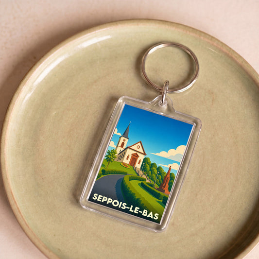 Porte-clés souvenir de la ville de Seppois-le-Bas avec une illustration stylisée.