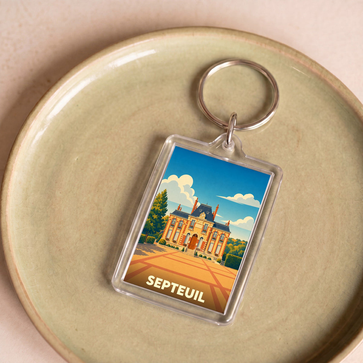 Porte-clés souvenir de la ville de Septeuil avec une illustration stylisée de son château.