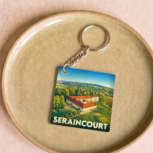 Porte-clés souvenir de la ville de Seraincourt avec une illustration stylisée d'un paysage local.
