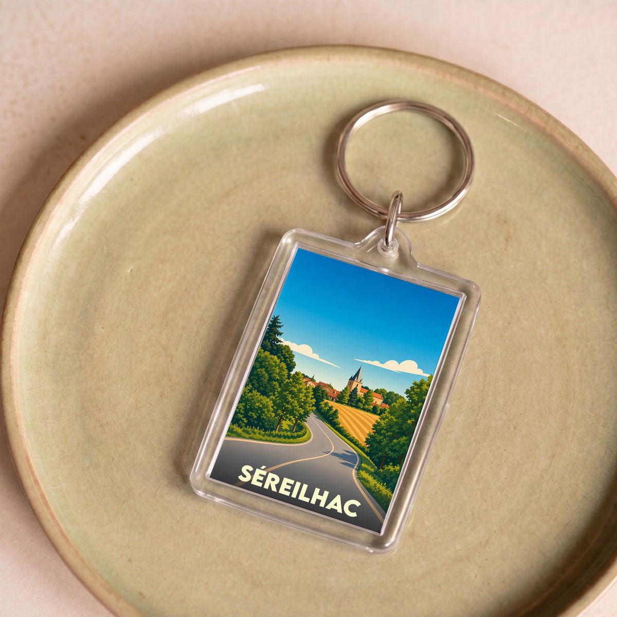Porte-clés souvenir de la ville de Séreilhac avec une illustration stylisée.