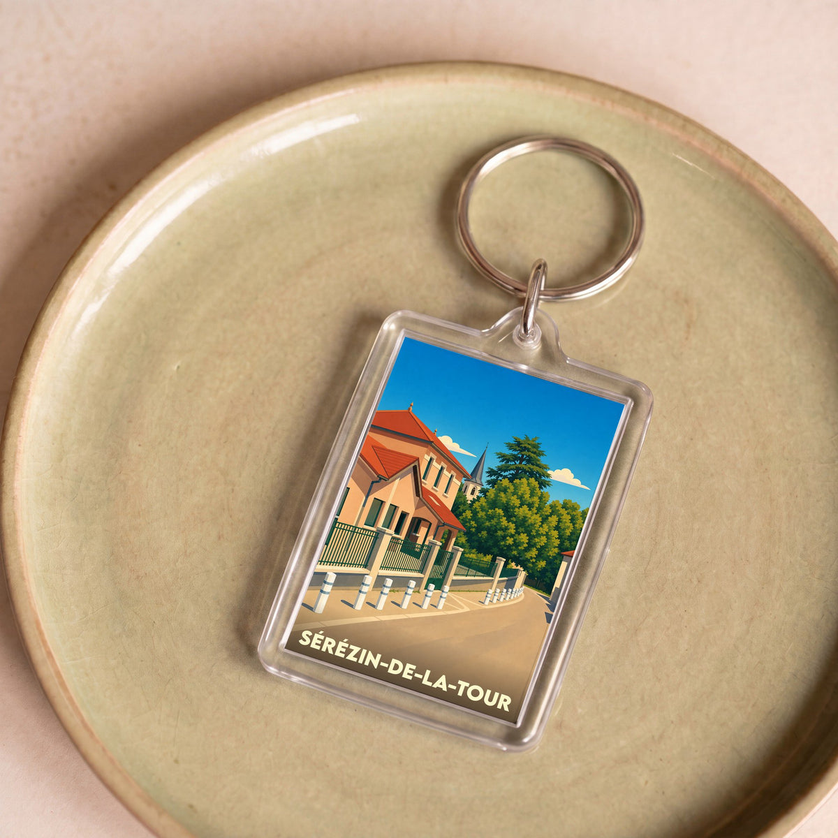 Porte-clés souvenir de la ville de Sérézin-de-la-Tour avec une illustration stylisée.