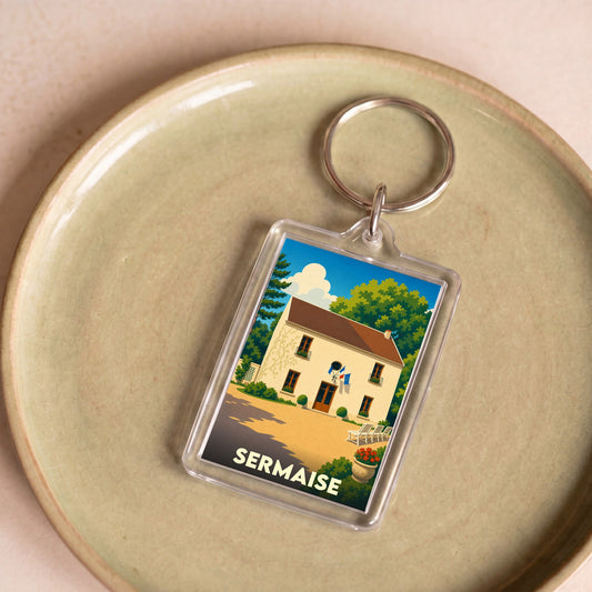 Porte-clés souvenir de la ville de Sermaise avec une illustration stylisée de sa mairie.