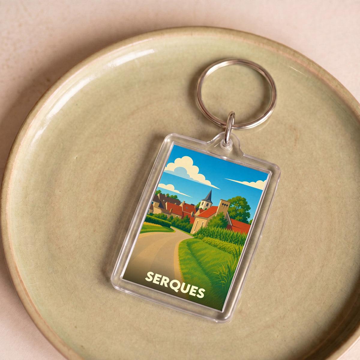 Porte-clés souvenir de la ville de Serques avec une illustration stylisée.