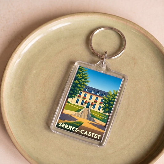 Porte-clés souvenir de la ville de Serres-Castet avec une illustration stylisée de sa mairie.