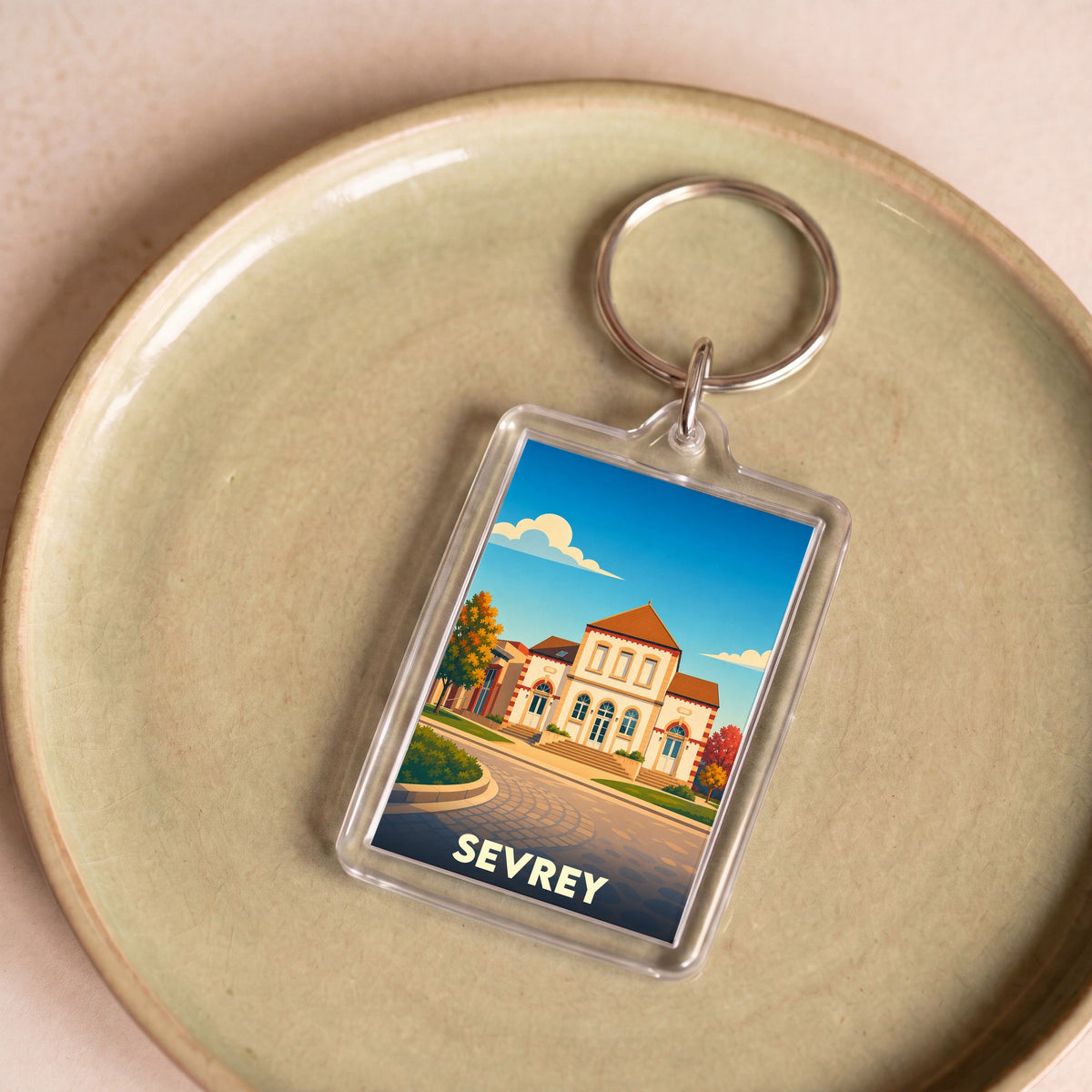 Porte-clés souvenir de la ville de Sevrey avec une illustration stylisée.