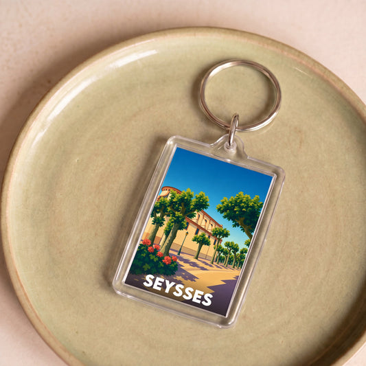 Porte-clés souvenir de la ville de Seysses avec une illustration stylisée.