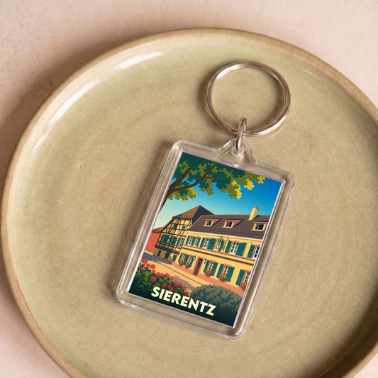 Porte-clés souvenir de la ville de Sierentz avec une illustration stylisée d'une maison traditionnelle à colombages.