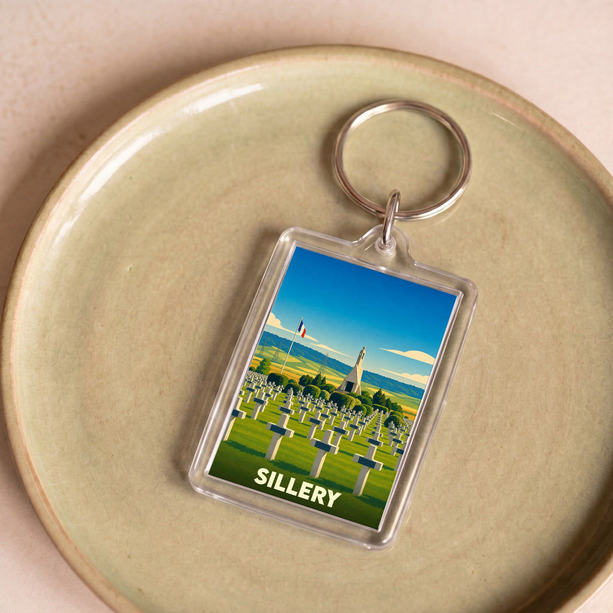 Porte-clés souvenir de la ville de Sillery avec une illustration stylisée de son cimetière militaire.