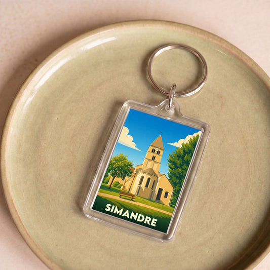 Porte-clés souvenir de la ville de Simandre avec une illustration stylisée de son église.