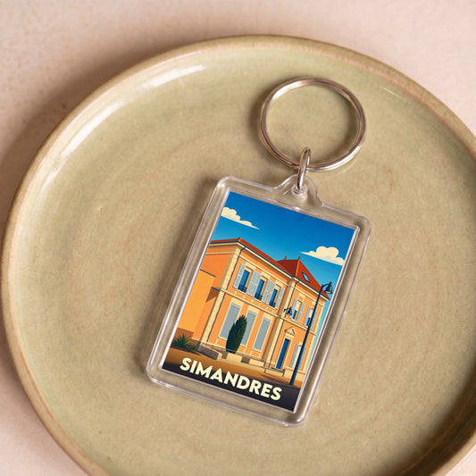Porte-clés souvenir de la ville de Simandres avec une illustration stylisée.