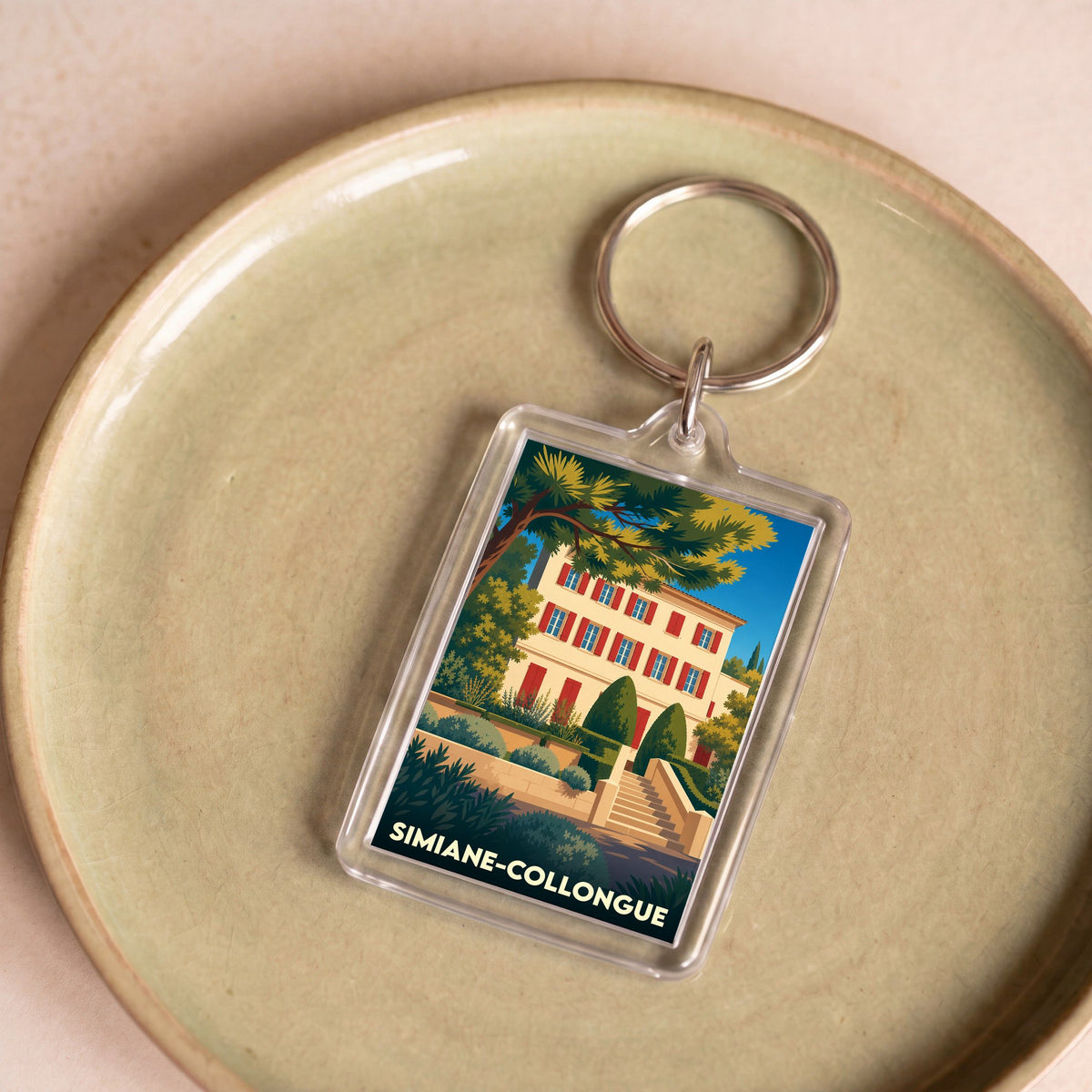 Porte-clés souvenir de la ville de Simiane-Collongue avec une illustration stylisée.