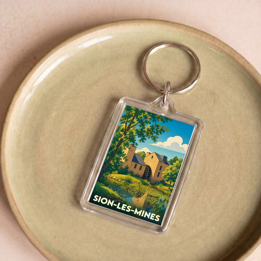 Porte-clés souvenir de la ville de Sion-les-Mines avec une illustration stylisée d'un moulin à eau.
