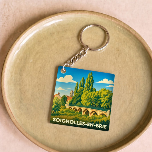 Porte-clés souvenir de la ville de Soignolles-en-Brie avec une illustration stylisée.