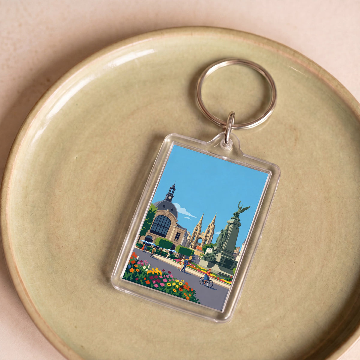 Porte-clés souvenir de la ville de Soissons avec une illustration stylisée.