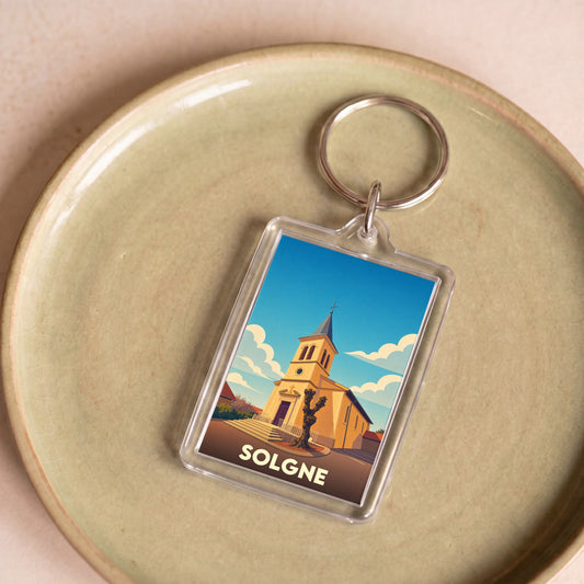 Porte-clés souvenir de la ville de Solgne avec une illustration stylisée de son église.