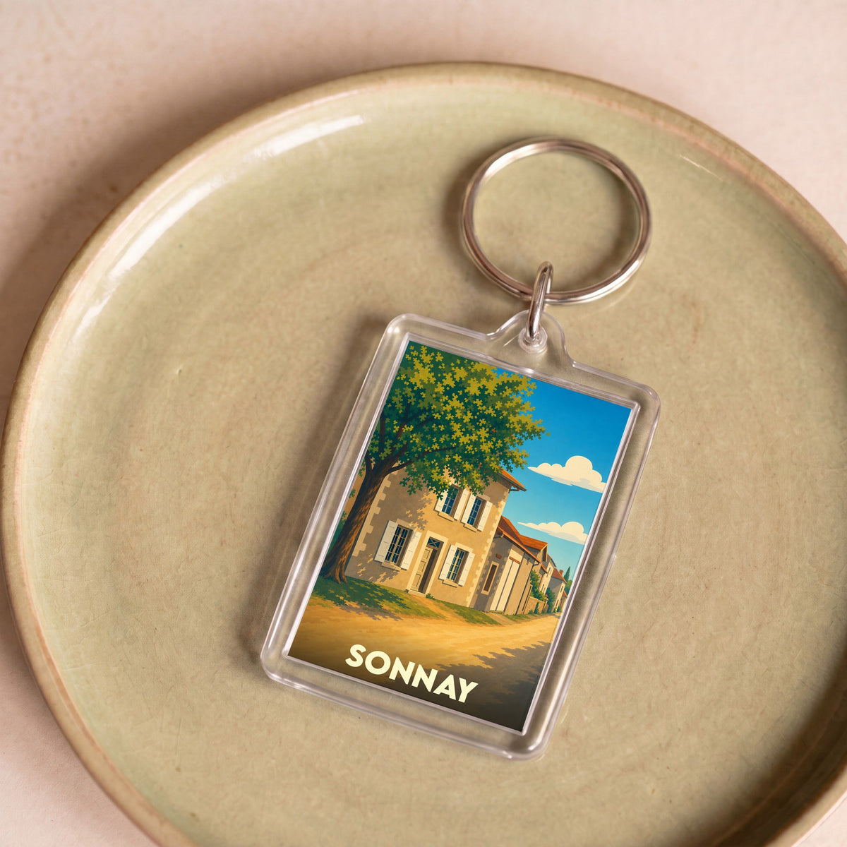 Porte-clés souvenir de la ville de Sonnay avec une illustration stylisée.