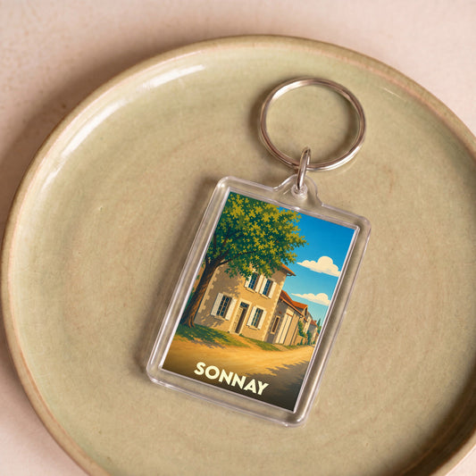 Porte-clés souvenir de la ville de Sonnay avec une illustration stylisée.
