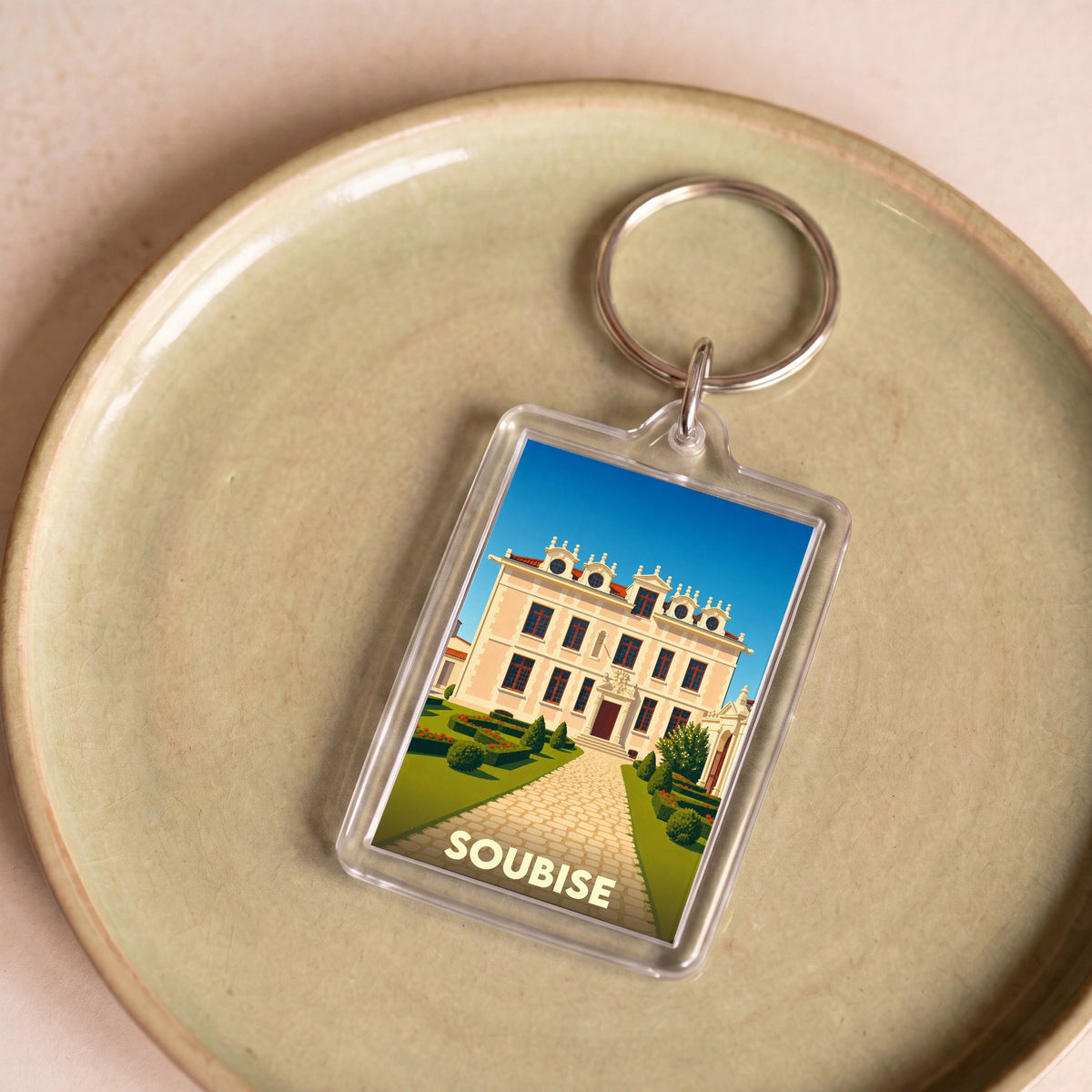 Porte-clés souvenir de la ville de Soubise avec une illustration stylisée de son patrimoine.