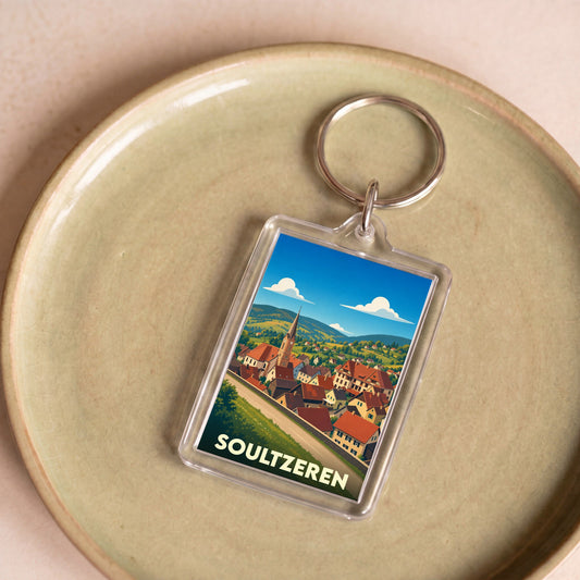 Porte-clés souvenir de la ville de Soultzeren avec une illustration stylisée.