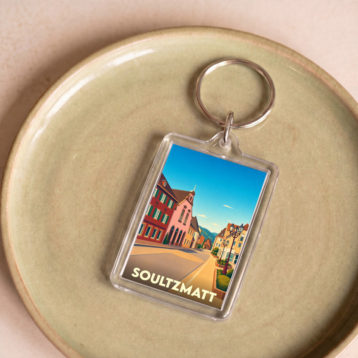 Porte-clés souvenir de la ville de Soultzmatt avec une illustration stylisée.