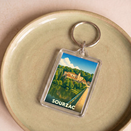 Porte-clés souvenir de la ville de Sourzac avec une illustration stylisée.