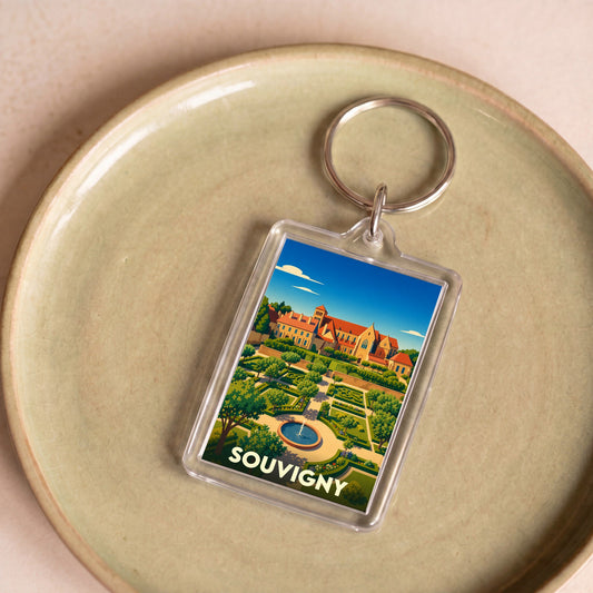 Porte-clés souvenir de la ville de Souvigny avec une illustration stylisée de son prieuré et de ses jardins.