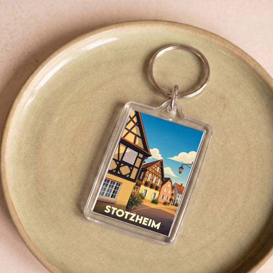 Porte-clés souvenir de la ville de Stotzheim avec une illustration stylisée de maisons à colombages.