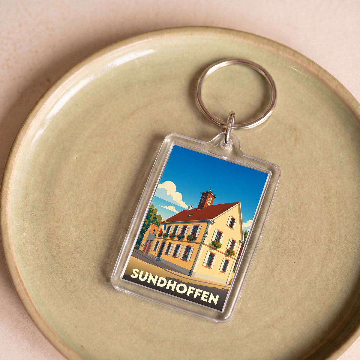 Porte-clés souvenir de la ville de Sundhoffen avec une illustration stylisée.