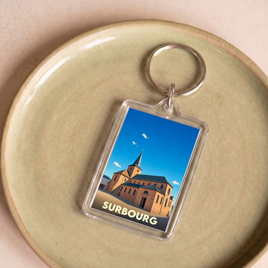 Porte-clés souvenir de la ville de Surbourg avec une illustration stylisée de son église.