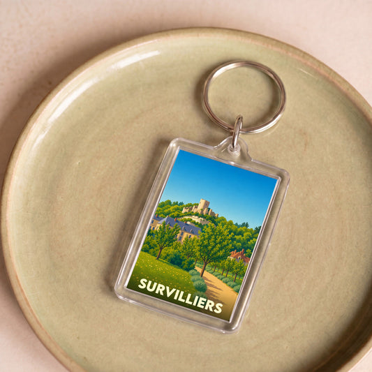Porte-clés souvenir de la ville de Survilliers avec une illustration stylisée d'un paysage local.