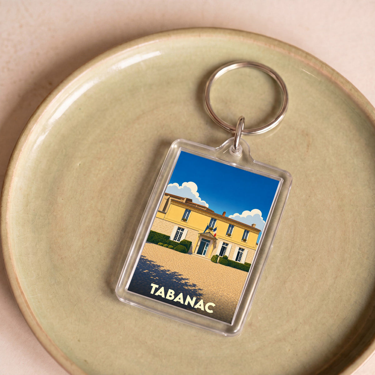 Porte-clés souvenir de la ville de Tabanac avec une illustration stylisée.