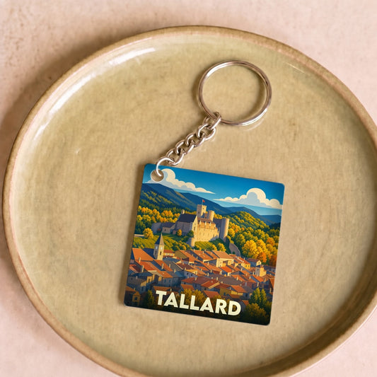 Porte-clés souvenir de la ville de Tallard avec une illustration stylisée de son château et de ses toits.