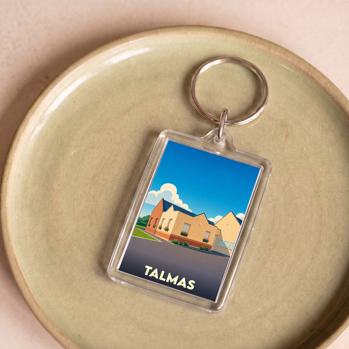 Porte-clés souvenir de la ville de Talmas avec une illustration stylisée.