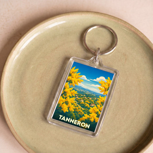Porte-clés souvenir de la ville de Tanneron avec une illustration colorée de mimosas en fleurs.