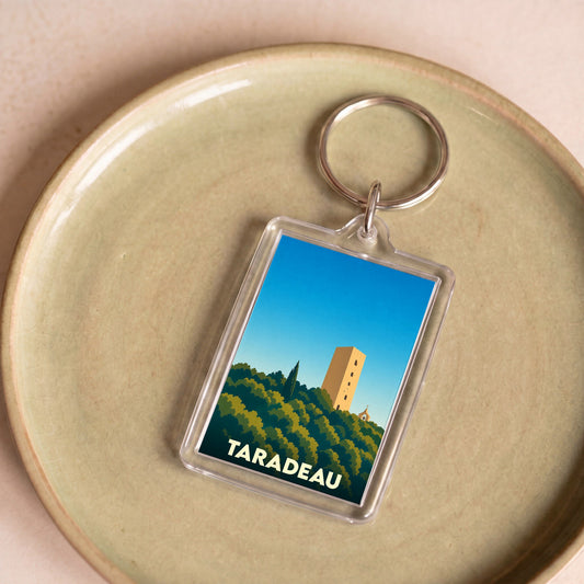 Porte-clés souvenir de la ville de Taradeau avec une illustration stylisée de sa tour médiévale.