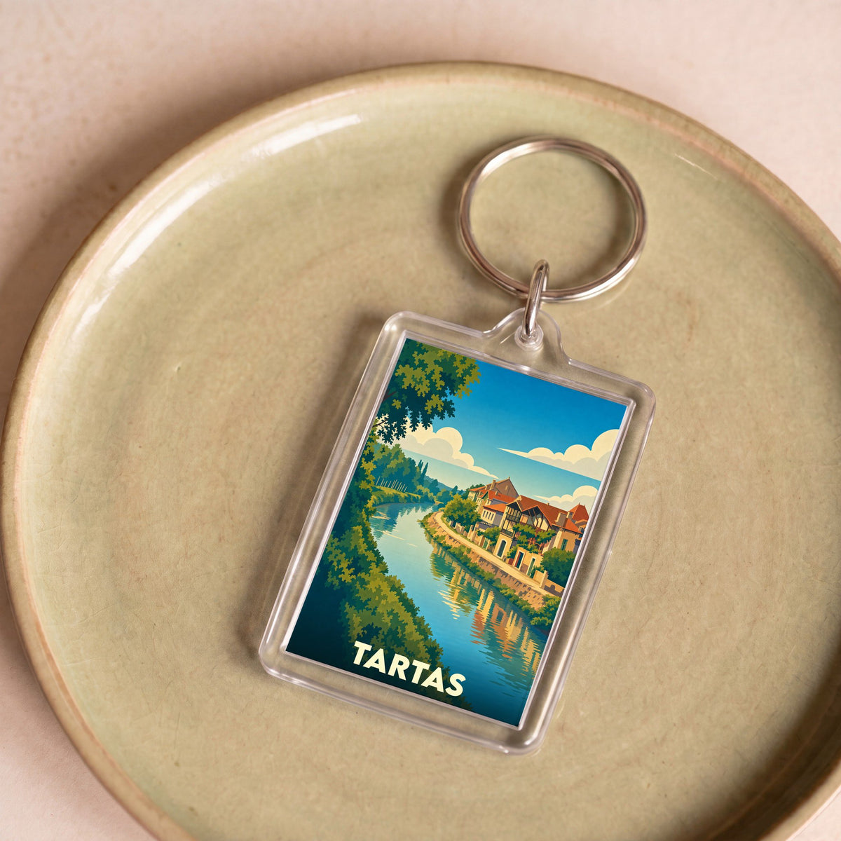 Porte-clés souvenir de la ville de Tartas avec une illustration stylisée des bords de la Midouze.