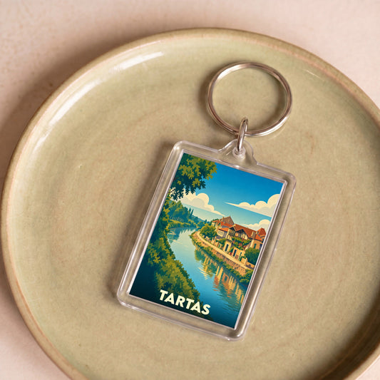 Porte-clés souvenir de la ville de Tartas avec une illustration stylisée des bords de la Midouze.