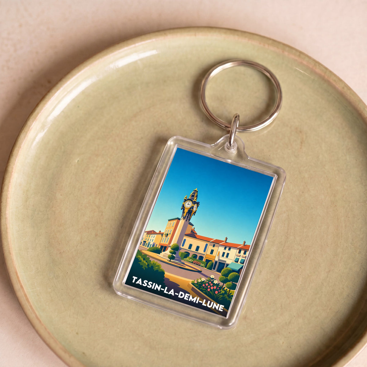 Porte-clés souvenir de la ville de Tassin-la-Demi-Lune avec une illustration stylisée.