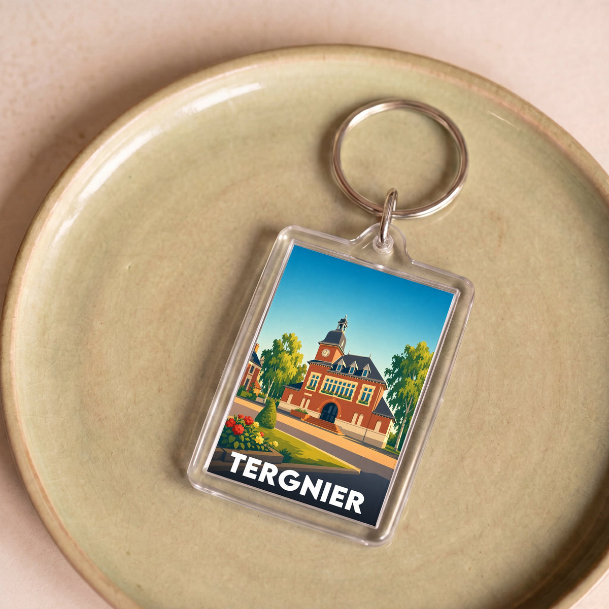Porte-clés souvenir de la ville de Tergnier avec une illustration stylisée.