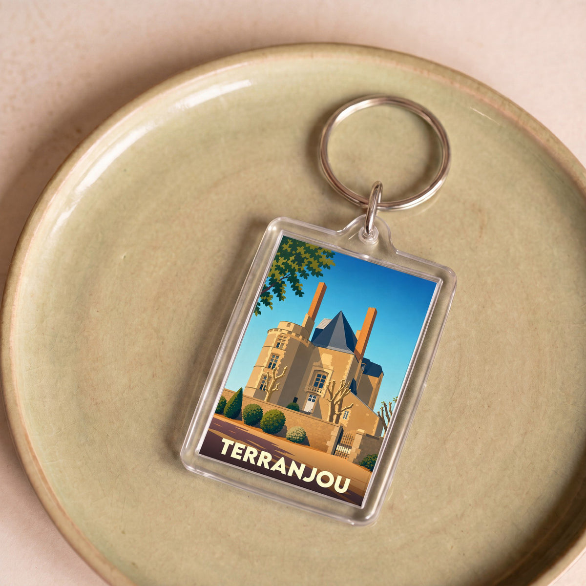 Porte-clés souvenir de la ville de Terranjou avec une illustration stylisée de son patrimoine.