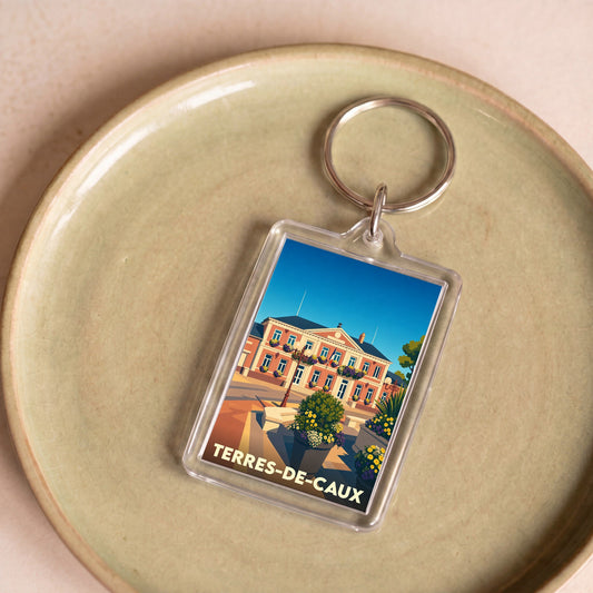 Porte-clés souvenir de la ville de Terres-de-Caux avec une illustration stylisée de la mairie.