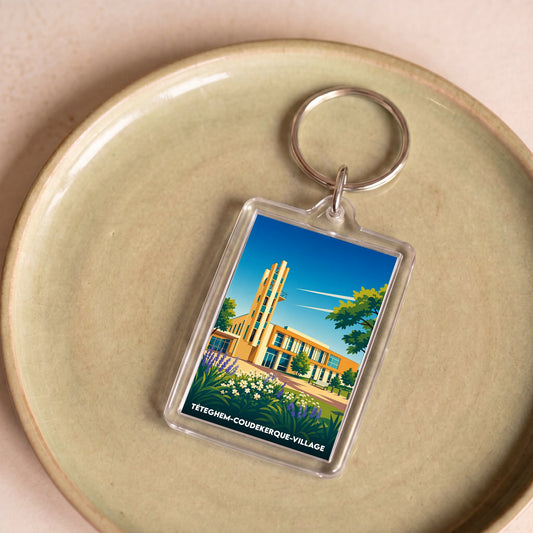 Porte-clés souvenir de la ville de Téteghem-Coudekerque-Village avec une illustration stylisée.