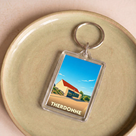 Porte-clés souvenir de la ville de Therdonne avec une illustration stylisée.
