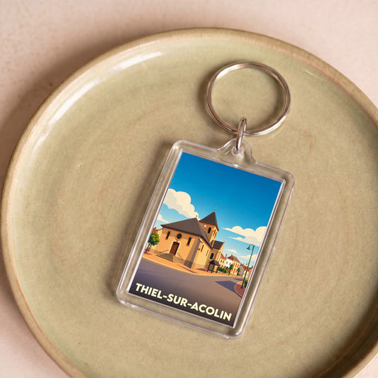 Porte-clés souvenir de la ville de Thiel-sur-Acolin avec une illustration stylisée de son église.