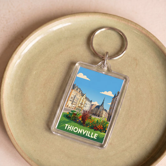 Porte-clés souvenir de la ville de Thionville avec une illustration stylisée.